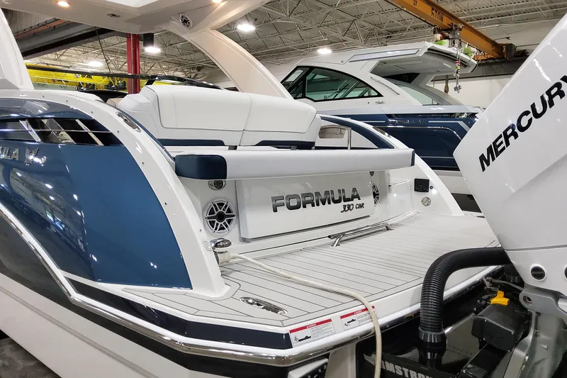 Slide: The Image of 2026 Formula 330 Crossover Bowrider OB with Mercury engine in showroom. - 11