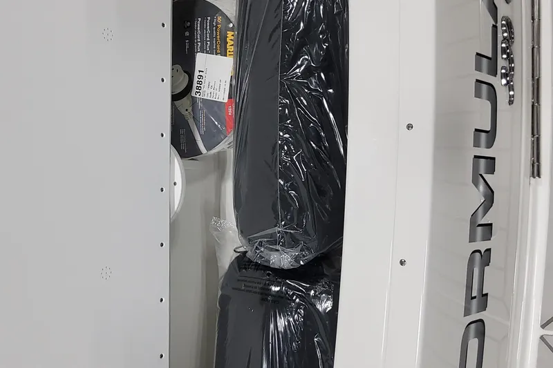 Slide: The Image of 2026 Formula 330 Crossover Bowrider OB storage compartment with packaged items and visible branding. - 14