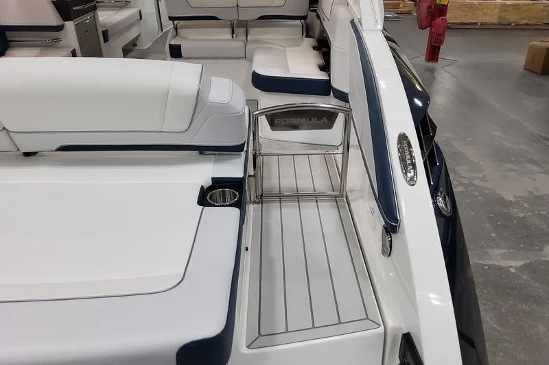 Slide: The Image of 2026 Formula 330 Crossover Bowrider OB interior with white seating and stainless steel accents. - 15