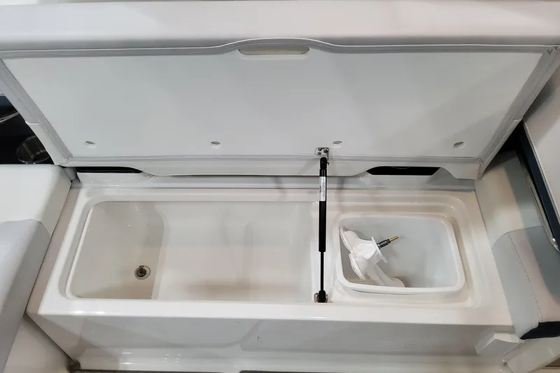 Slide: The Image of 2026 Formula 330 Crossover Bowrider OB storage compartment with open lid and hydraulic support. - 22