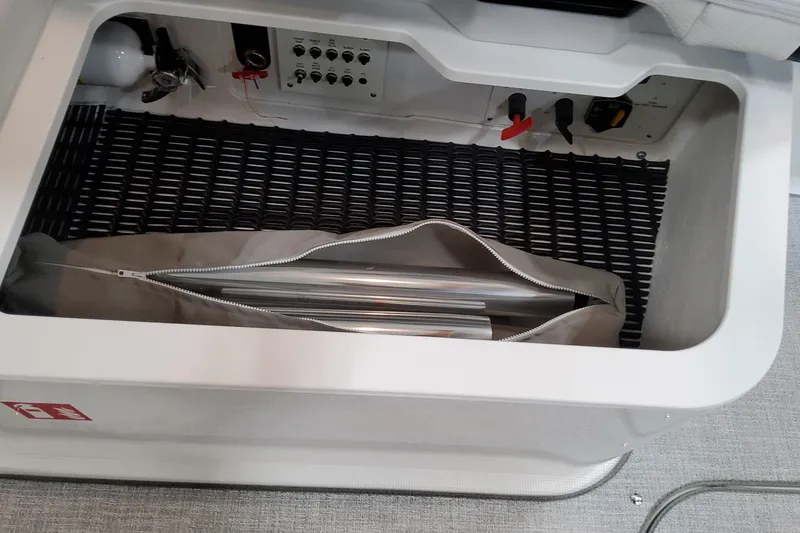 Slide: The Image of Storage compartment in 2026 Formula 330 Crossover Bowrider OB with equipment and controls. - 24