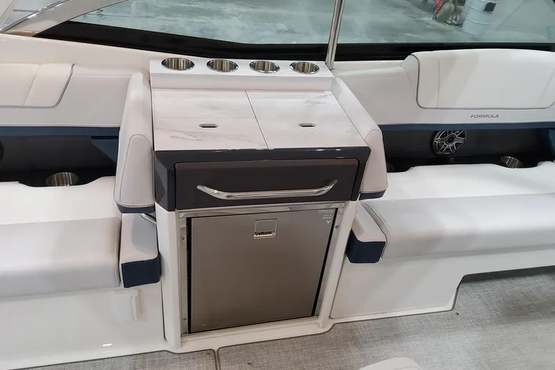 Slide: The Image of 2026 Formula 330 Crossover Bowrider OB interior with seating, cup holders, and storage. - 27