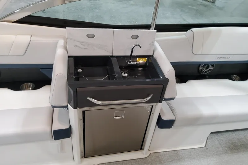 Slide: The Image of 2026 Formula 330 Crossover Bowrider OB interior with sink and seating area. - 28