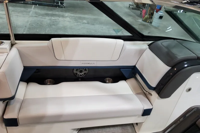 Slide: The Image of 2026 Formula 330 Crossover Bowrider OB interior seating with cup holders and speaker. - 29