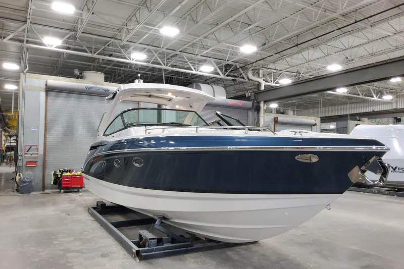 Slide: The Image of 2026 Formula 330 Crossover Bowrider OB in a showroom, showcasing sleek design and modern features. - 3