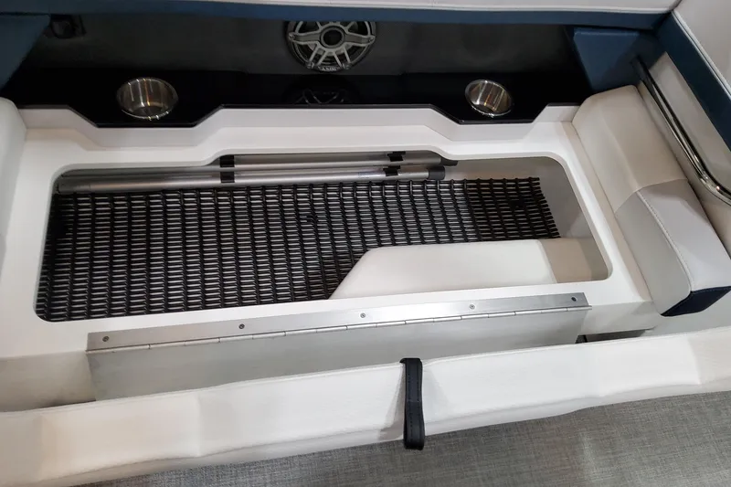 Slide: The Image of 2026 Formula 330 Crossover Bowrider OB interior storage compartment with cup holders and speaker. - 30
