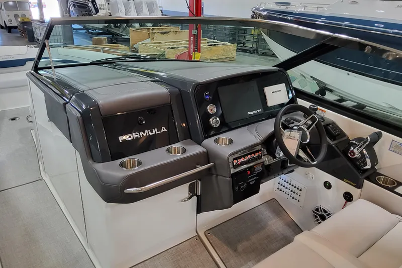 Slide: The Image of 2026 Formula 330 Crossover Bowrider OB cockpit with modern controls and navigation system. - 32