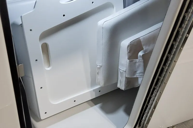 Slide: The Image of 2026 Formula 330 Crossover Bowrider OB interior storage compartment with white cushions. - 41