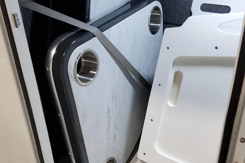 Slide: The Image of 2026 Formula 330 Crossover Bowrider OB interior storage with secured table and cup holders. - 42