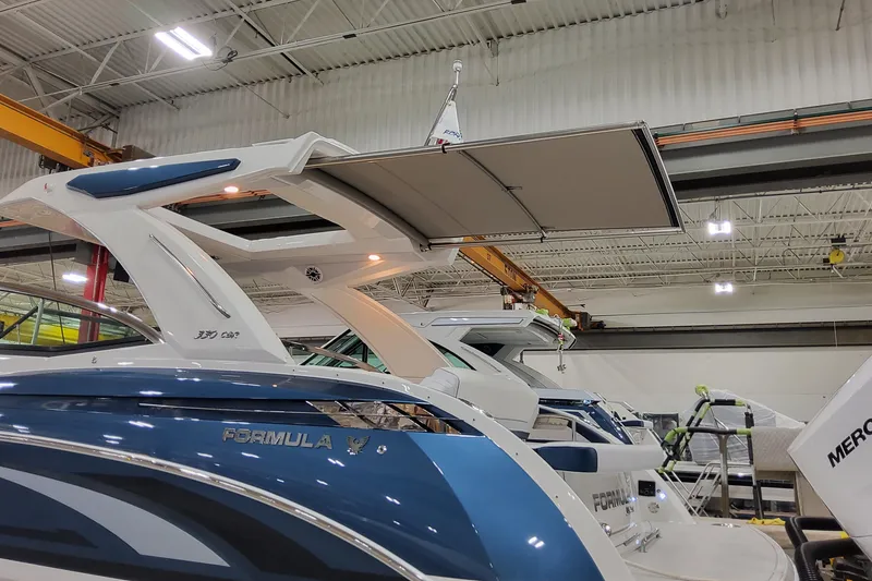 Slide: The Image of 2026 Formula 330 Crossover Bowrider OB in a showroom, showcasing sleek design and modern features. - 55