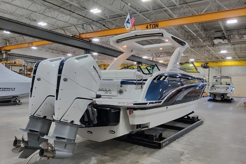 Slide: The Image of 2026 Formula 330 Crossover Bowrider OB in a warehouse, featuring dual Mercury outboard engines. - 6