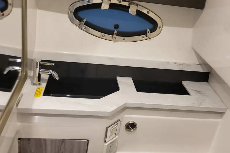 Slide: The Image of 2026 Formula 330 Crossover Bowrider OB interior sink with modern design and porthole window. - 60