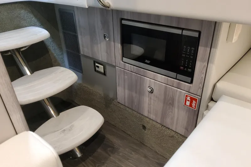 Slide: The Image of Interior of 2026 Formula 330 Crossover Bowrider OB with microwave and stairs. - 62