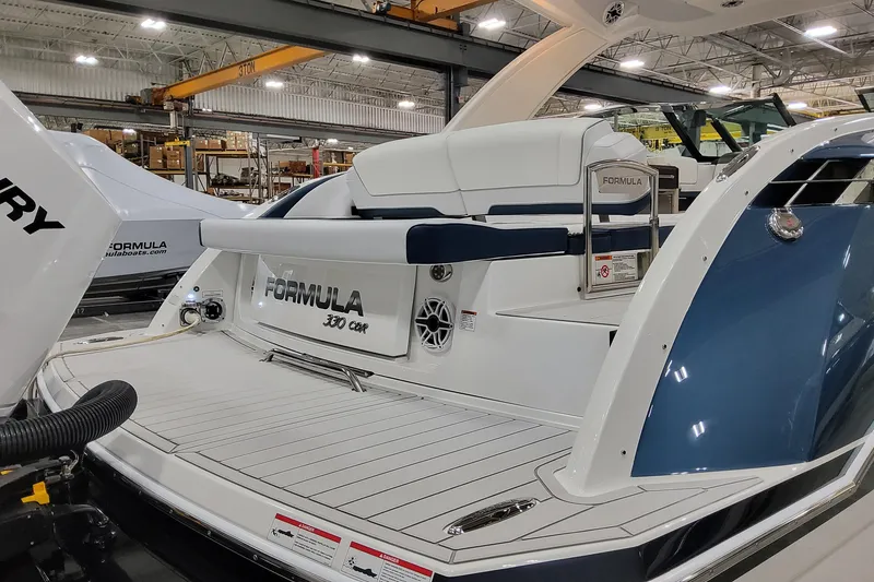 Slide: The Image of 2026 Formula 330 Crossover Bowrider OB in a showroom, showcasing sleek design and luxury features. - 7