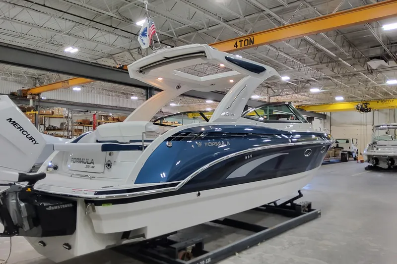 Slide: The Image of 2026 Formula 330 Crossover Bowrider OB in a warehouse, featuring sleek design and Mercury engine. - 9