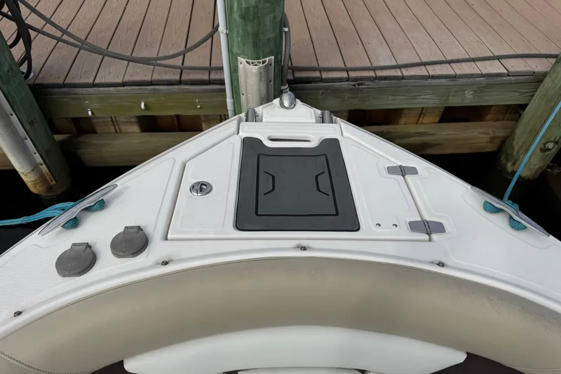 Slide: The Image of 2015 Regal 2700 Bowrider boat bow at dock, featuring storage compartments. - 10