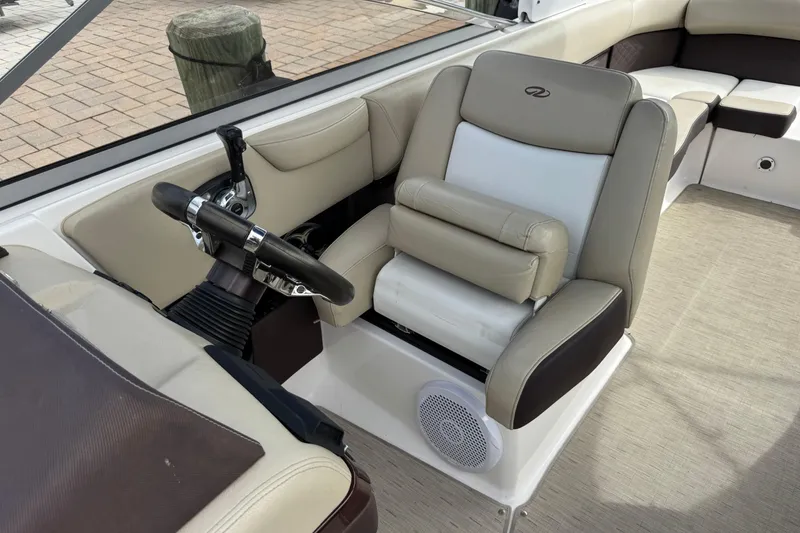 Slide: The Image of 2015 Regal 2700 Bowrider interior with beige seating and steering wheel. - 12