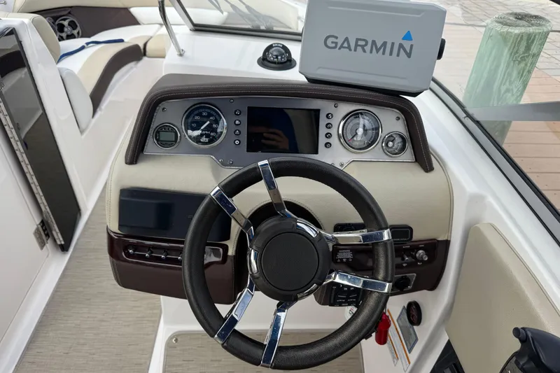 Slide: The Image of 2015 Regal 2700 Bowrider dashboard with Garmin navigation system and steering wheel. - 25