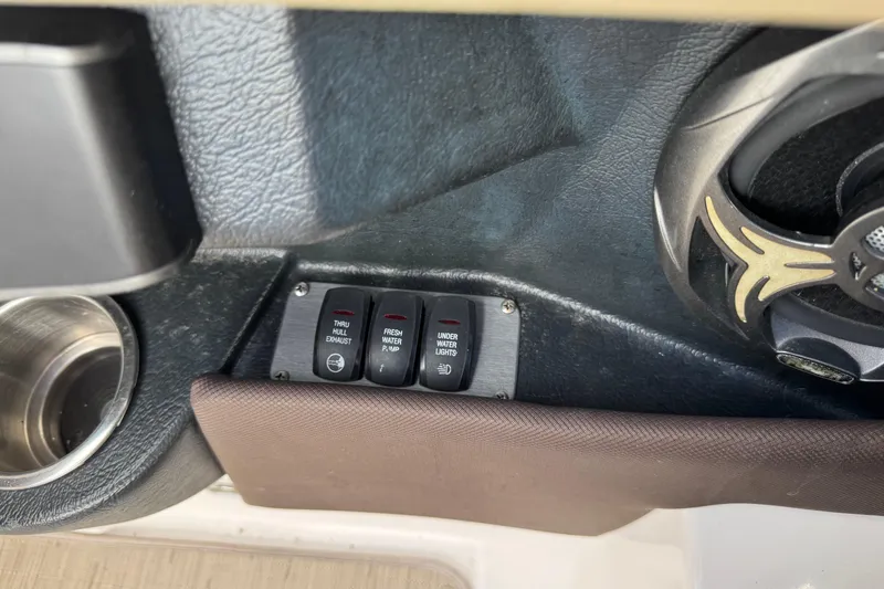 Slide: The Image of Control panel of a 2015 Regal 2700 Bowrider boat with switches and speaker. - 26