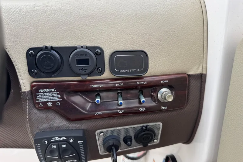 Slide: The Image of Control panel of a 2015 Regal 2700 Bowrider boat with switches and voltmeter. - 27