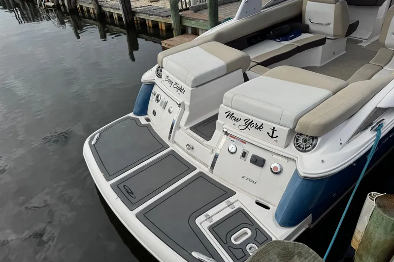 Slide: The Image of 2015 Regal 2700 Bowrider boat docked, featuring spacious seating and sleek design. - 4