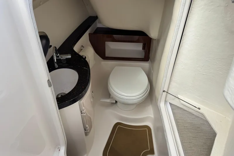 Slide: The Image of 2015 Regal 2700 Bowrider boat bathroom with sink and toilet. - 5