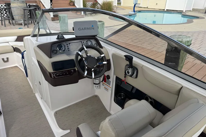 Slide: The Image of 2015 Regal 2700 Bowrider cockpit with Garmin navigation, steering wheel, and controls. - 6