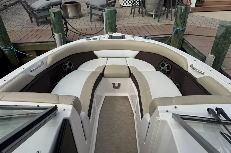 Slide: The Image of 2015 Regal 2700 Bowrider boat interior with beige seating at dock. - 7