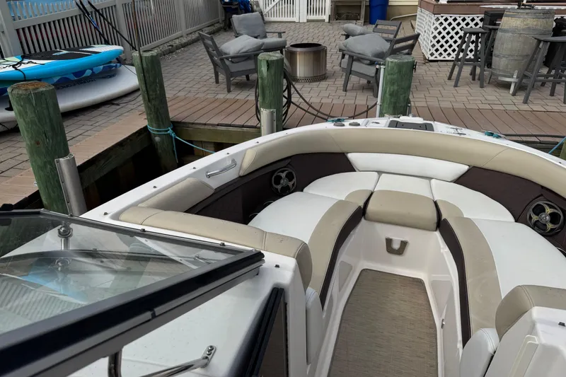 Slide: The Image of 2015 Regal 2700 Bowrider boat docked, featuring spacious seating and modern design. - 8