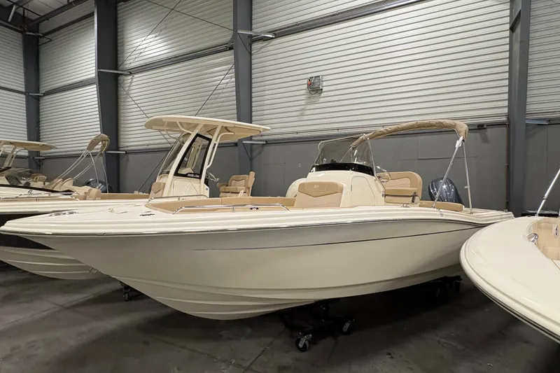 The Image of 2025 Scout 215 XSF boat in showroom, featuring sleek design and modern amenities. - 0