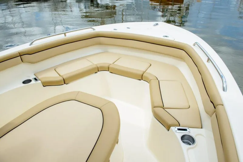 Slide: The Image of Manufacturer Provided Image: 2025 Scout 215 XSF boat interior with beige seating and cup holders. - 16