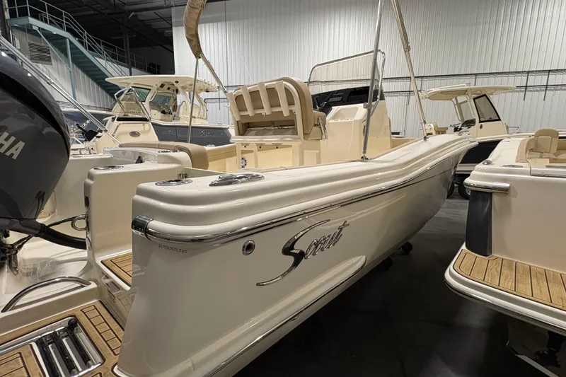 Slide: The Image of 2025 Scout 215 XSF boat in showroom, featuring sleek design and Yamaha engine. - 4