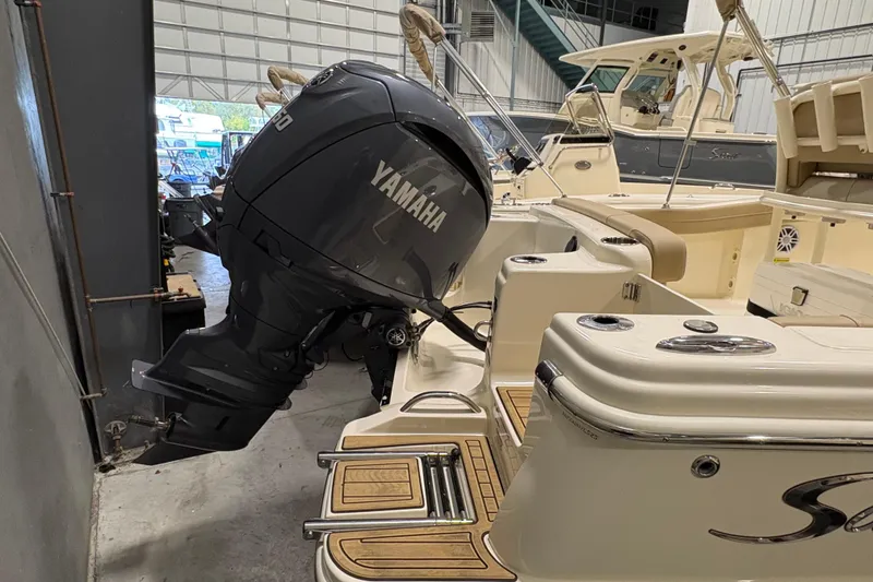 Slide: The Image of 2025 Scout 215 XSF boat with Yamaha outboard motor in a storage facility. - 5
