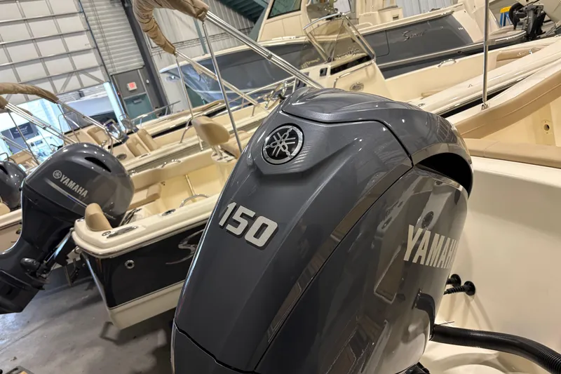 Slide: The Image of 2025 Scout 215 XSF boat with Yamaha 150 outboard engine in showroom. - 6
