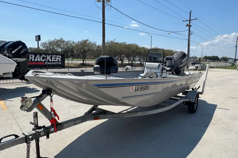 Slide: The Image of 2009 G3 1860 CC boat on trailer, parked outdoors under clear sky. - 11