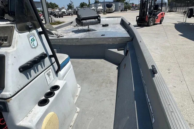 Slide: The Image of 2009 G3 1860 CC boat interior with console and seating, parked outdoors. - 6