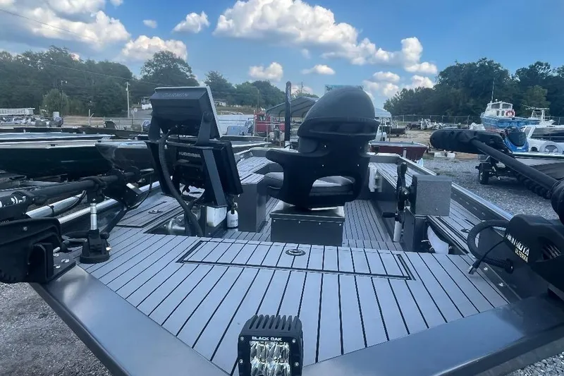 Slide: The Image of 2021 Weld-Craft 1860 PF boat with advanced navigation equipment and seating, docked outdoors. - 3