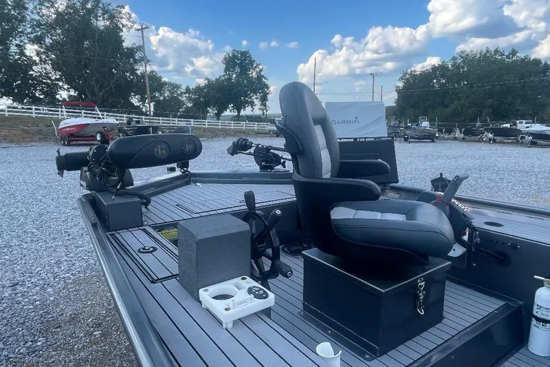 Slide: The Image of 2021 Weld-Craft 1860 PF boat interior with seating and fishing equipment on a sunny day. - 6