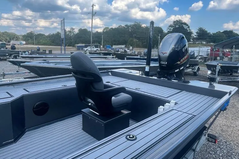 Slide: The Image of 2021 Weld-Craft 1860 PF boat with Yamaha 90 engine, parked outdoors under cloudy sky. - 7