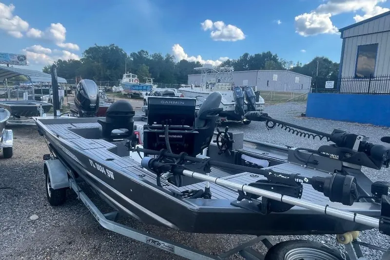 Slide: The Image of 2021 Weld-Craft 1860 PF boat with Garmin equipment, parked on a trailer in a marina. - 8