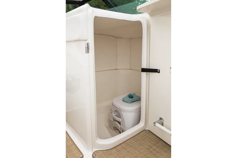 Slide: The Image of Manufacturer Provided Image: 2020 Sea Ray SPX 230 boat interior with compact toilet. - 5