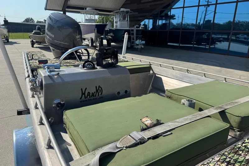 Slide: The Image of 2013 Hanko 19 SC boat with Yamaha engine, green seating, and Garmin equipment. - 13