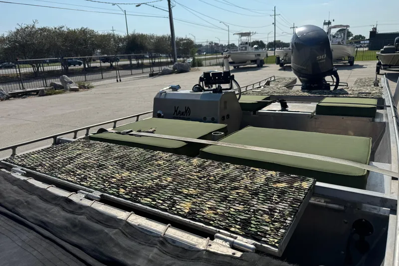 Slide: The Image of Hanko 19 SC boat, 2013 model, with camouflage seating and a 90 HP outboard motor. - 14