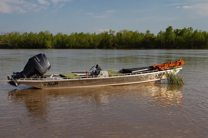 Slide: The Image of Boat on river, Hanko 19 SC, 2013 model, with Yamaha motor, near lush green trees. - 19