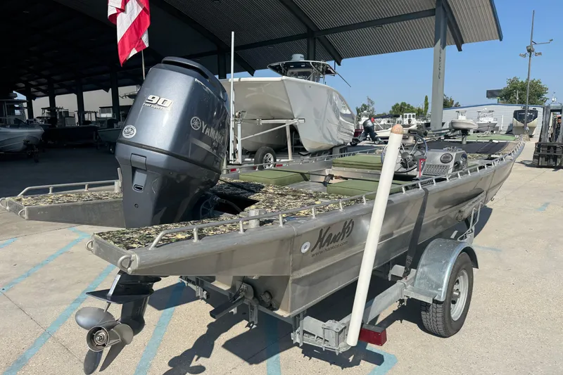 Slide: The Image of 2013 Hanko 19 SC boat with Yamaha 90 engine on trailer, parked under a canopy. - 7
