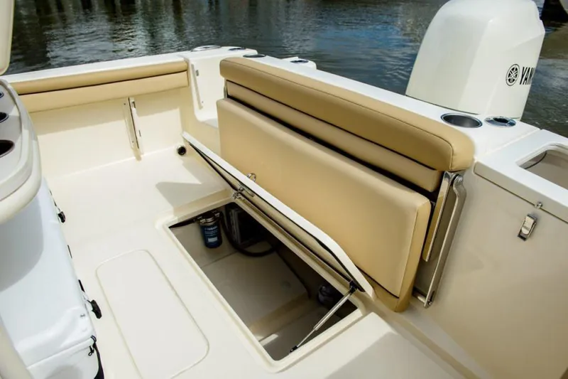 Slide: The Image of Manufacturer Provided Image: 2025 Scout 215 XSF boat interior with tan seating and storage compartment. - 29