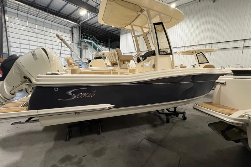 Slide: The Image of 2025 Scout 215 XSF boat in indoor showroom, side view. - 3
