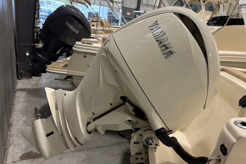 Slide: The Image of 2025 Scout 215 XSF boat with Yamaha outboard motor in showroom. - 4