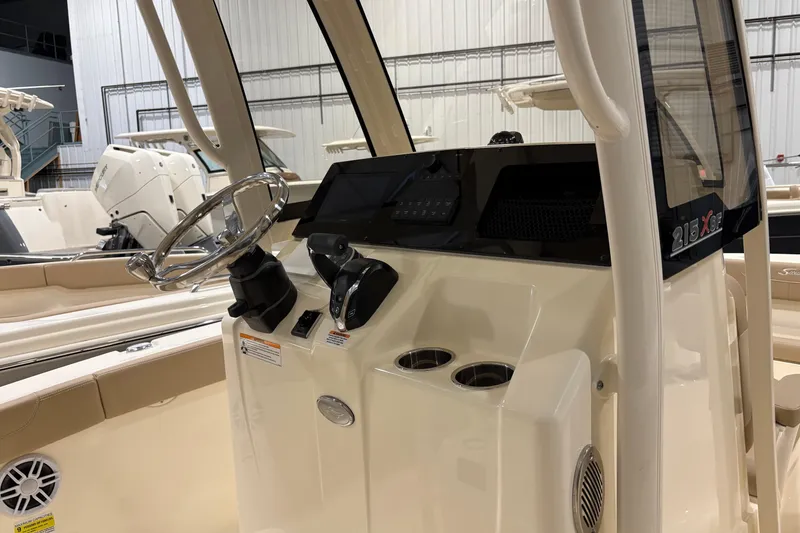 Slide: The Image of 2025 Scout 215 XSF boat interior with steering wheel and control panel. - 5