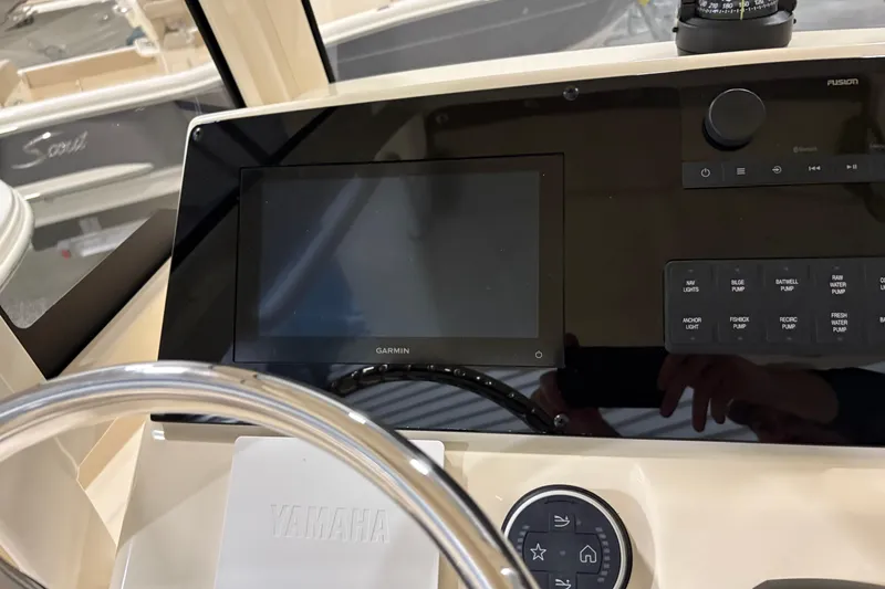 Slide: The Image of 2025 Scout 215 XSF boat dashboard with Garmin display and Yamaha controls. - 6
